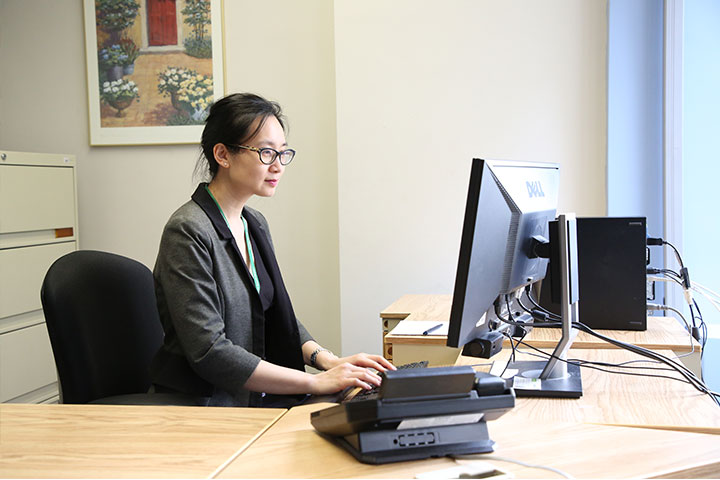 woman typing at desk