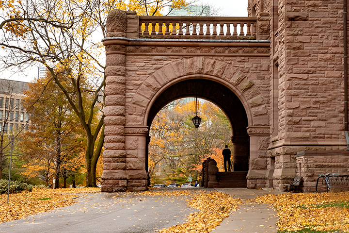 Side entrance of Legislative Building with orange leaves on the driveway in front