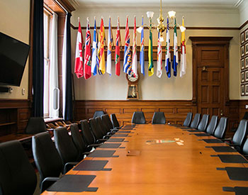 a boardroom with a long table and chairs